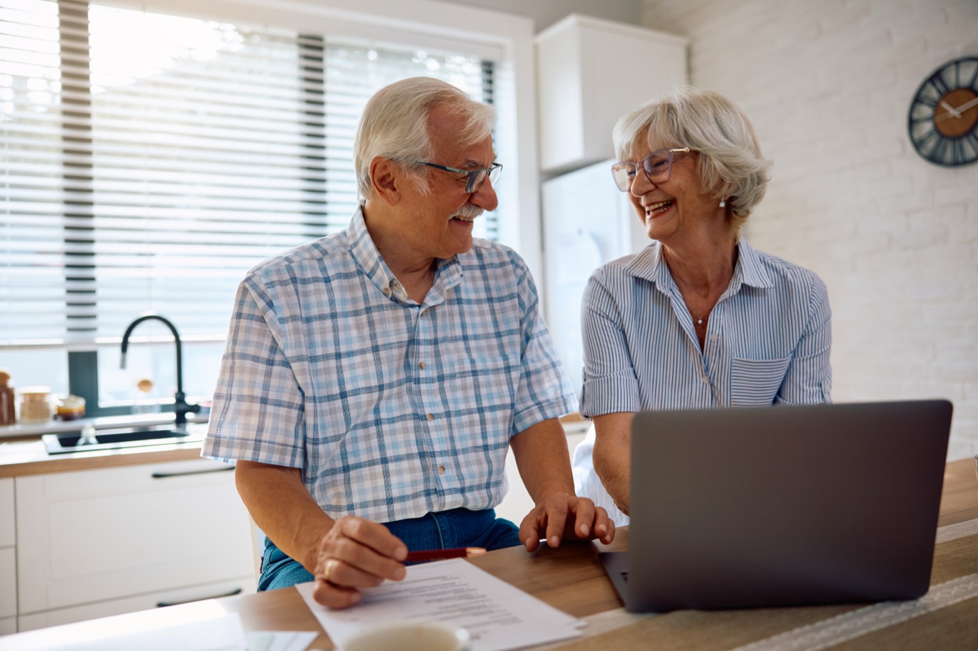 A senior couple reviewing their home finances together at home
